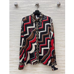 Pucci vintage print set: a combination of a draped shirt paired with high-waisted wide-leg pants, featuring contrasting wave patterns and classic chain elements. Shirt in sizes S, M, and L