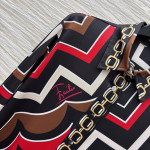 Pucci vintage print set: a combination of a draped shirt paired with high-waisted wide-leg pants, featuring contrasting wave patterns and classic chain elements. Shirt in sizes S, M, and L