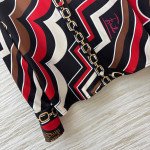 Pucci vintage print set: a combination of a draped shirt paired with high-waisted wide-leg pants, featuring contrasting wave patterns and classic chain elements. Shirt in sizes S, M, and L