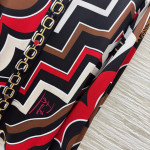 Pucci vintage print set: a combination of a draped shirt paired with high-waisted wide-leg pants, featuring contrasting wave patterns and classic chain elements. Shirt in sizes S, M, and L