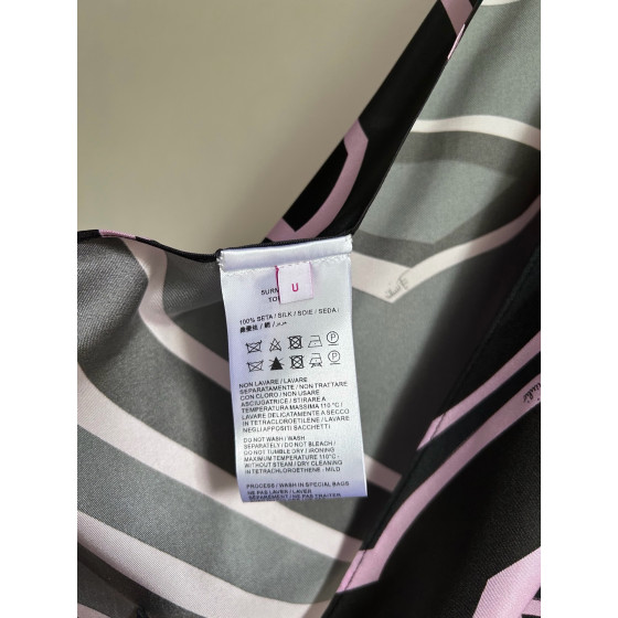 Pucci silk halter top with print, made of 100% silk twill, featuring a signature geometric swirl print all over. It has a halter neckline, a backless design with lace-up details, and each printed piece is unique.